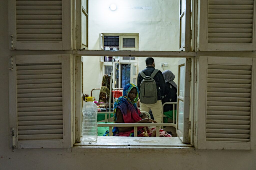 A woman and her child wait for treatment