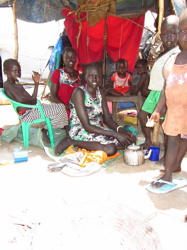 A family in their makeshift shelter at Mahad camp.