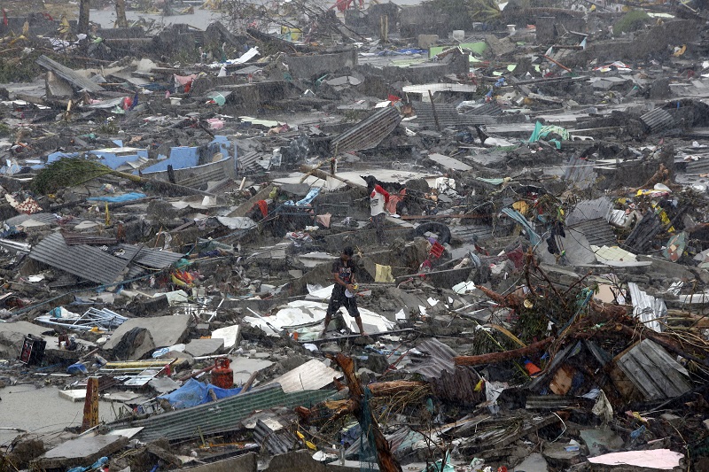 Local people salvage belongings from the ruins of their houses after Typhoon Haiyan battered Tacloban city, the Philippines.