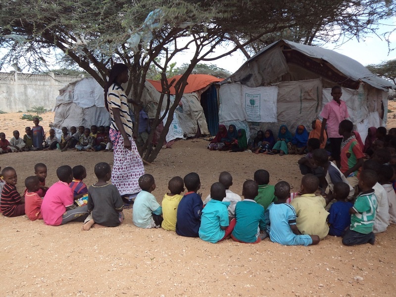A class is delivered outside in a camp on the outskirts of Mogadishu.