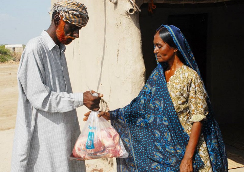 Sakina and her husband with their Qurbani meat package.