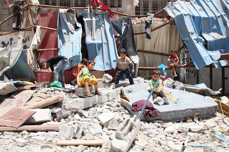 Children play amidst the rubble during the most recent conflict in Gaza.