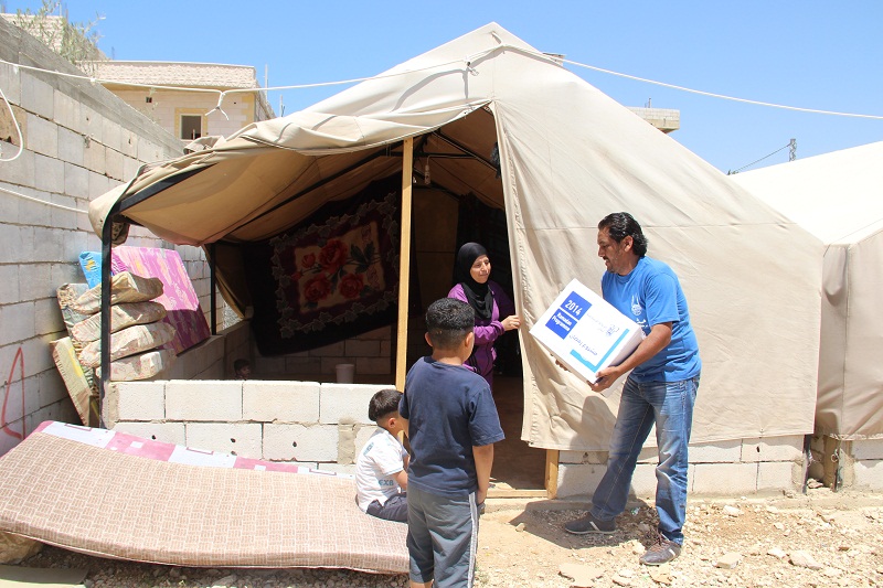 Receiving aid; the tent where Abo Abdo and his family live.