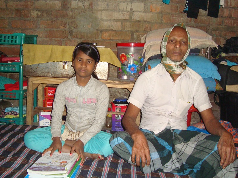 Baishakhi with her school books in her home.