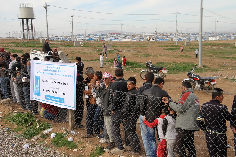 Syrian refugees queue for aid in Gwelan camp, Iraqi-Kurdistan.