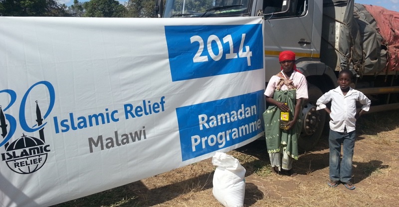 Baina and her son collecting their Ramadan foodpack.