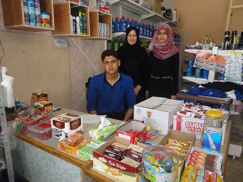 Najla with her children, who she is able to support through her business.