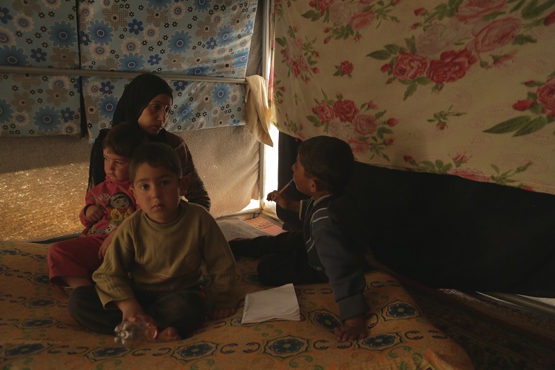 Um Omar and her children inside their tent.