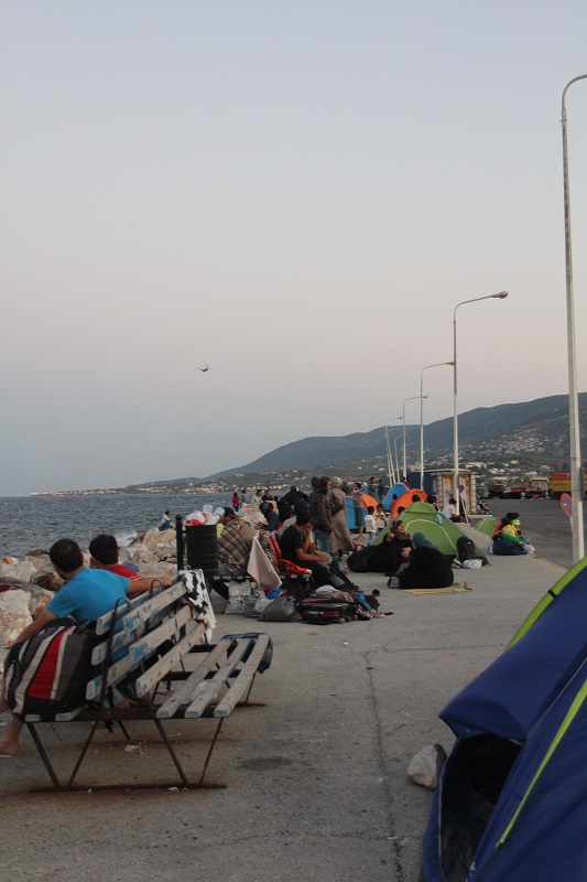 Along the harbor of Mytilene, refugees wait to board a ferry to Athens so they can continue their journey.