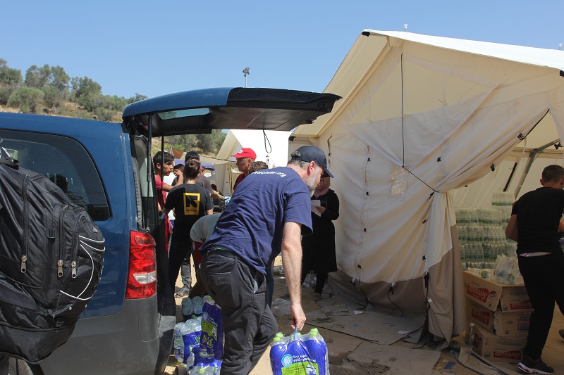 Islamic Relief and IRC distribute bottled water to refugees.
