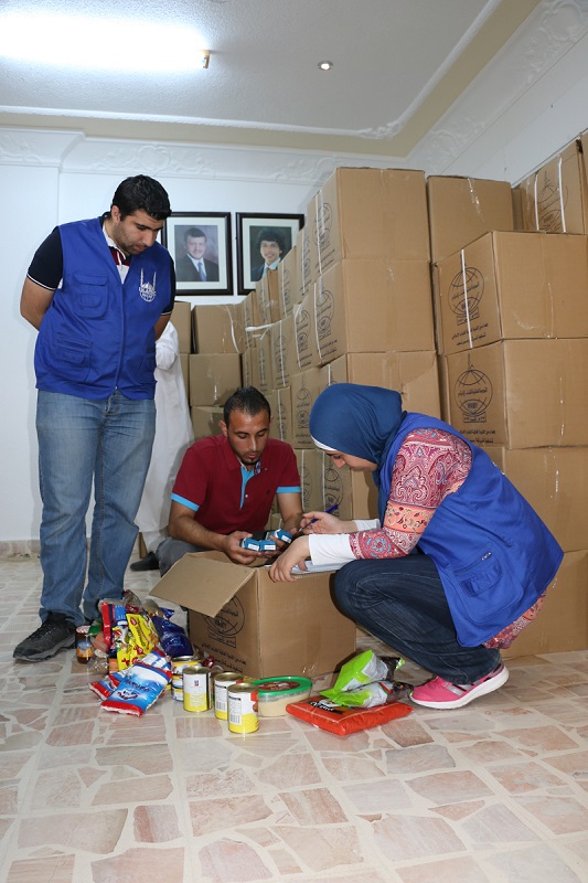 Islamic Relief staff catalogue foodpacks for distribution to refugees.