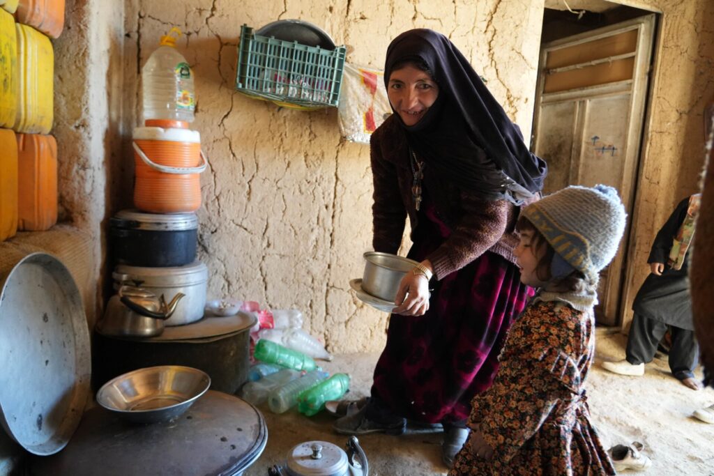 Bibi Jan prepares breakfast for her children in her home village on the outskirts of Feroz Koh, Ghor province