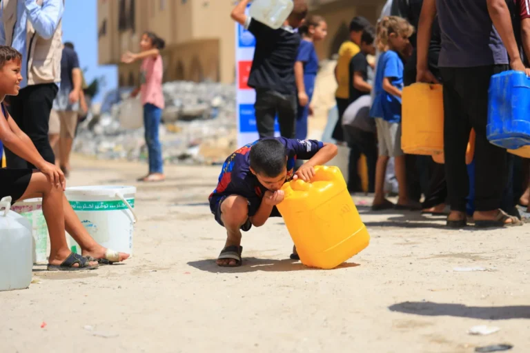 boy drinking water in Gaza