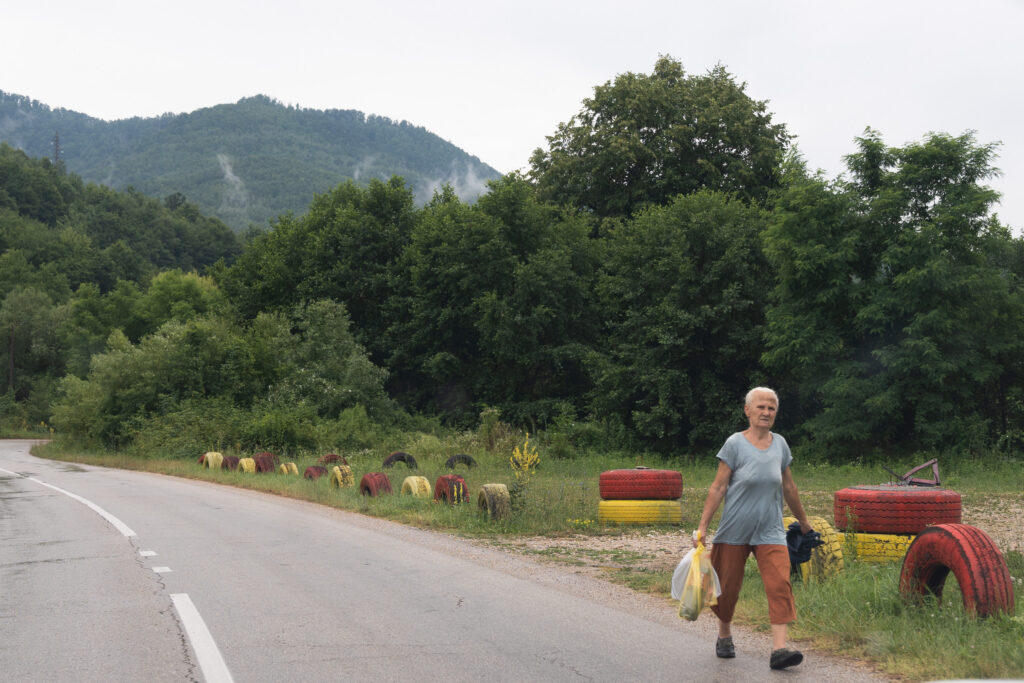 A woman carrying produce in Srebrenica